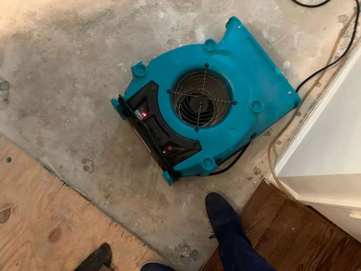 Air mover drying subfloor during Commercial Water Damage Restoration in Homer Glen
